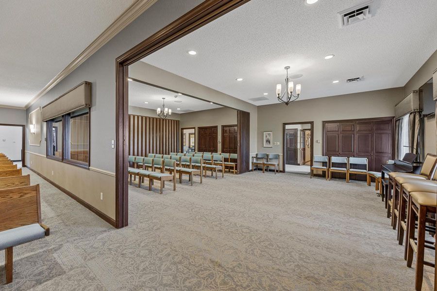 A large room with a lot of chairs and benches in it.