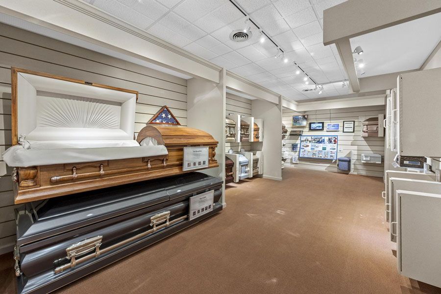 A large room with a lot of coffins on display.