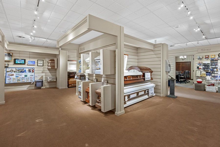 A room filled with lots of coffins in a funeral home.
