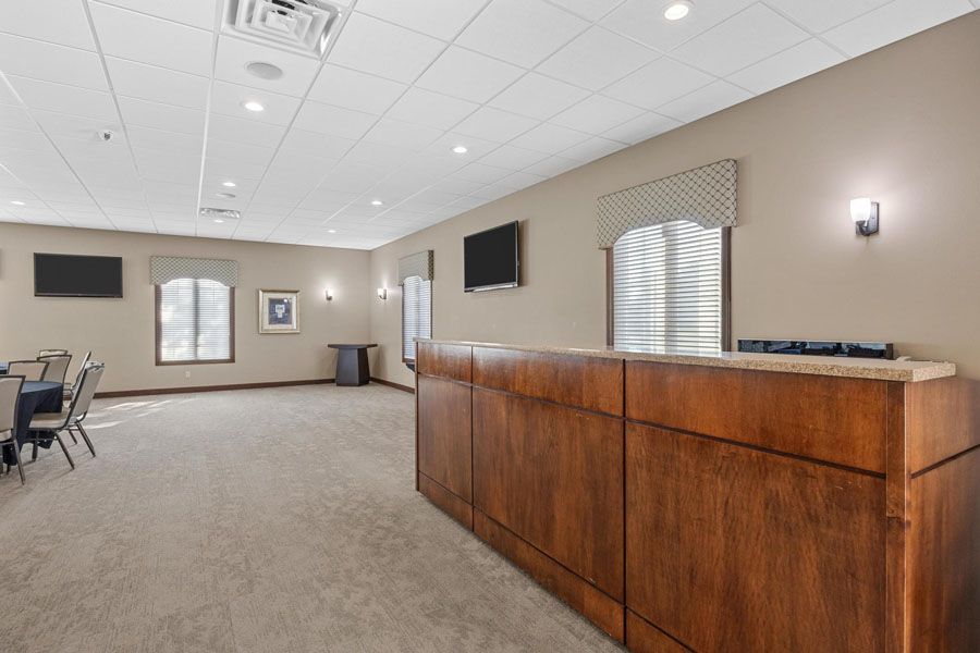 A large room with a wooden counter in the middle of it.