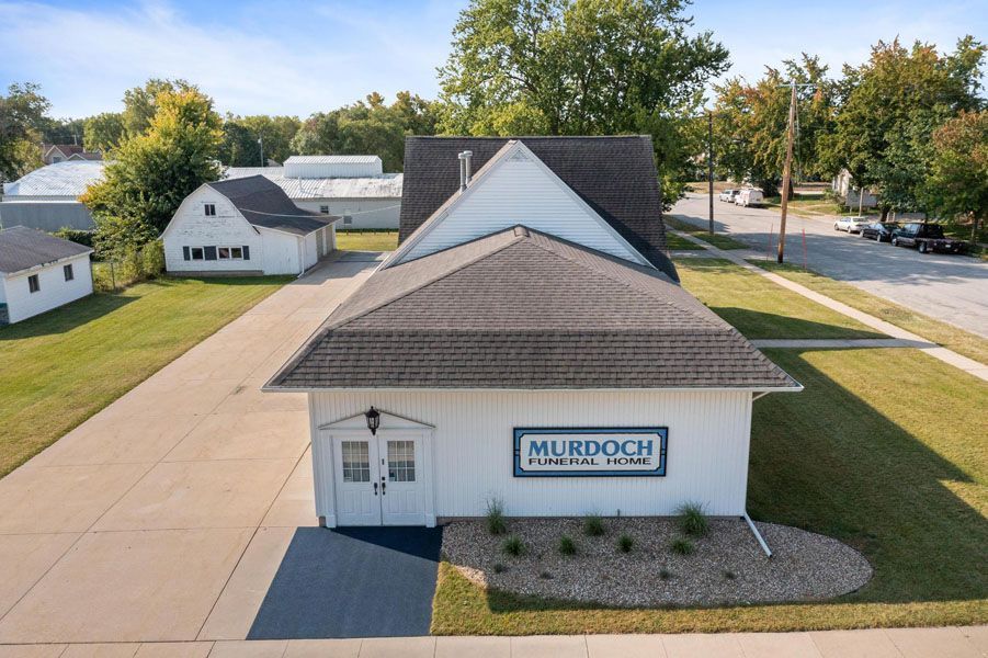 A white building with a sign that says murdoch on it