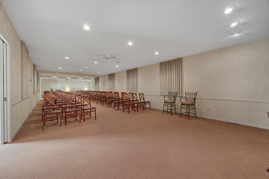 A large room with rows of chairs in it.