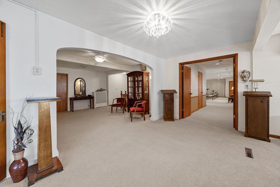 A large room with a lot of furniture and a chandelier in the ceiling.