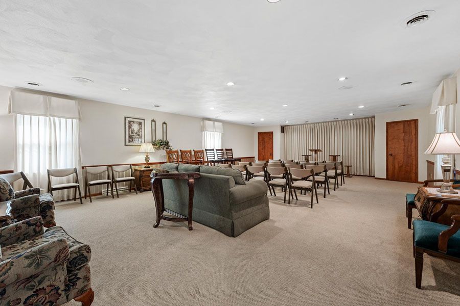 A large room with a lot of furniture and chairs in it.