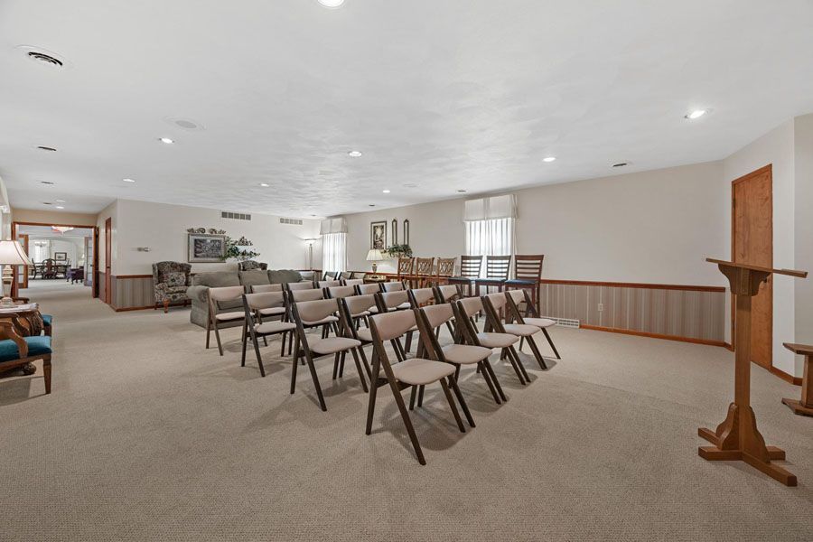 A large room with rows of chairs and a podium.