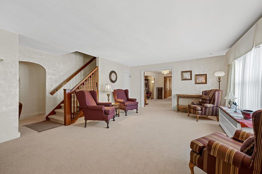 A living room filled with furniture and a staircase.