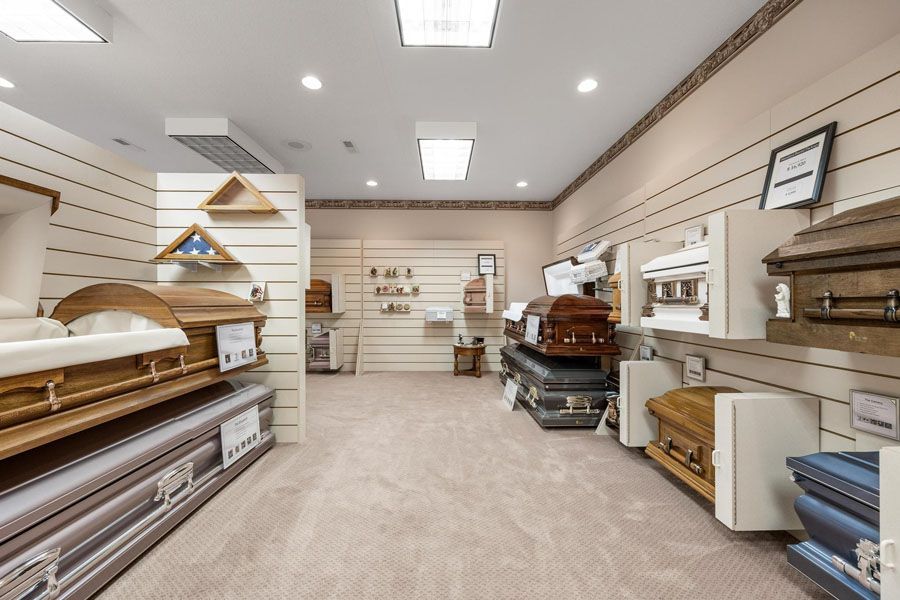 A room filled with lots of coffins in a funeral home.