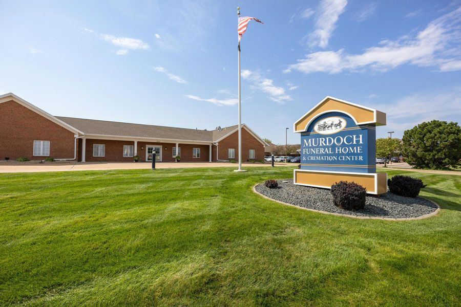 A funeral home with a sign in front of it.