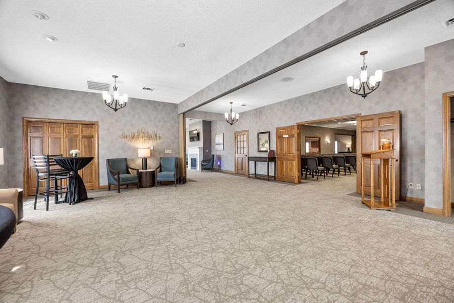A large empty room with a table and chairs in it.