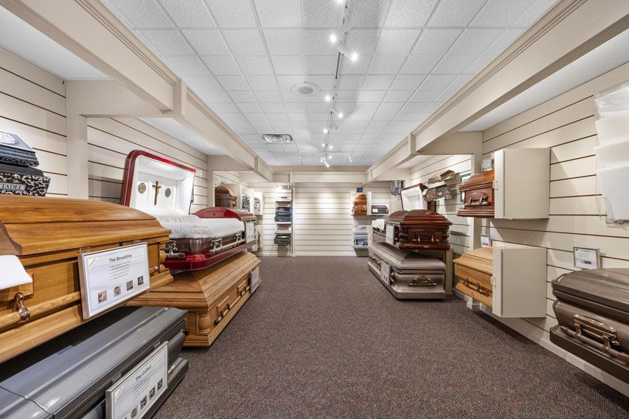 A large room filled with lots of coffins in a funeral home.