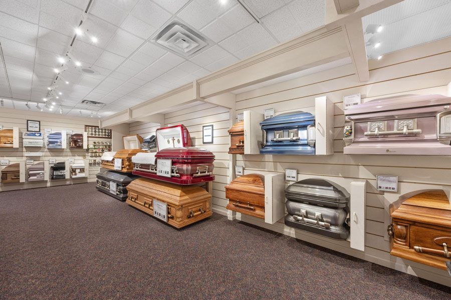 A room filled with lots of coffins in a funeral home.