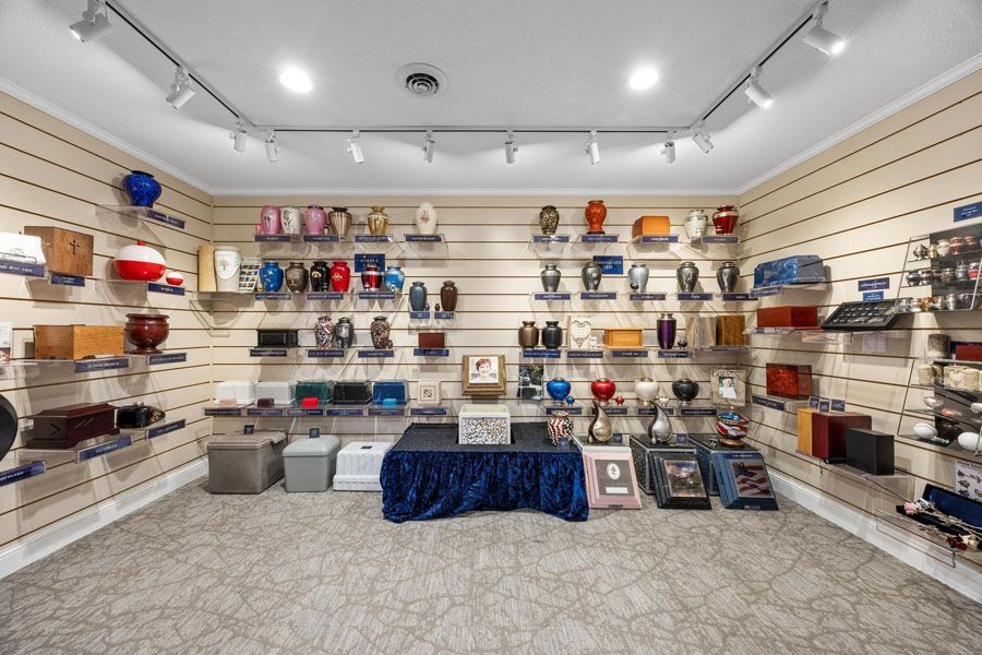 A large room filled with lots of urns and vases on shelves.