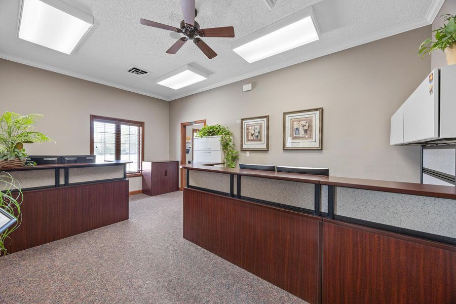 There is a ceiling fan in the corner of the room.