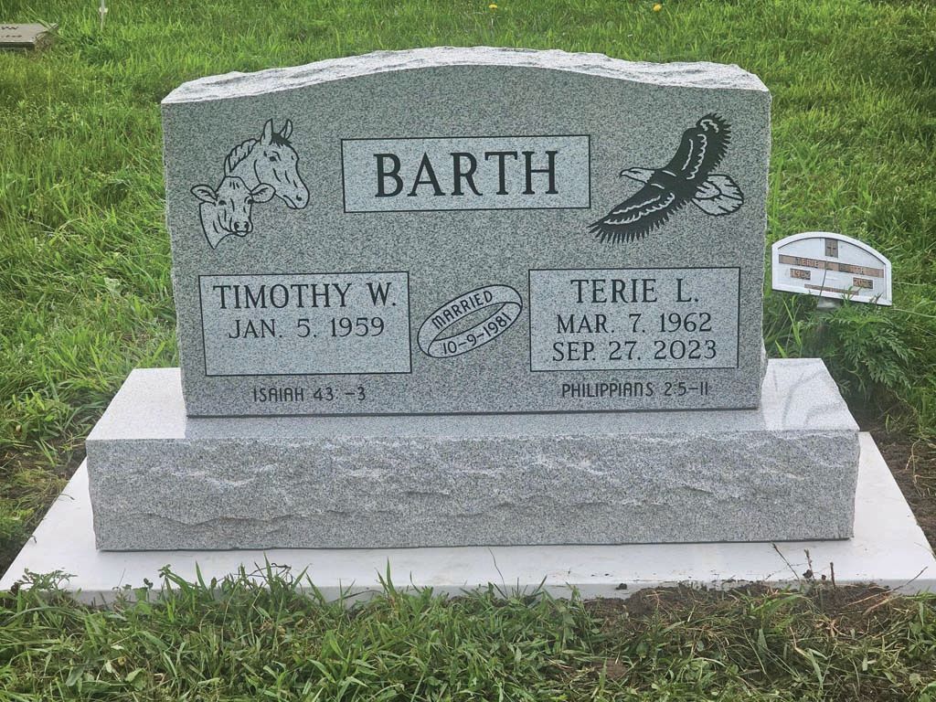 Gravestone for the Barth family with two name plaques in a grassy cemetery.