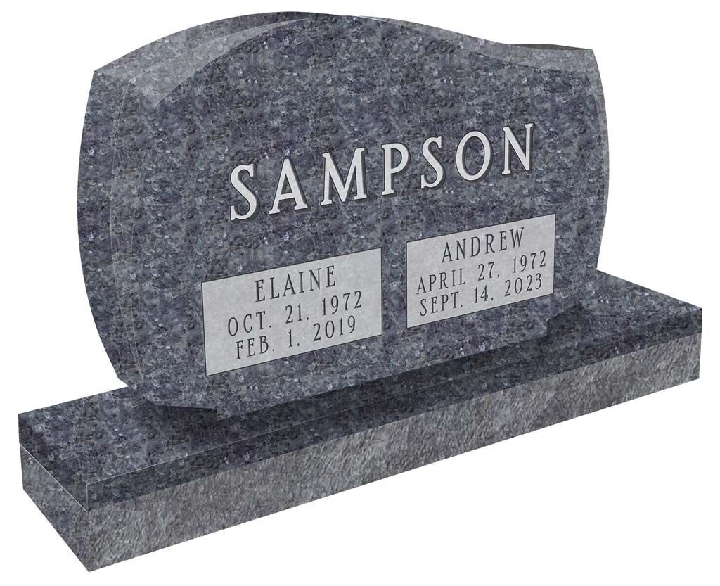 Gray granite gravestone with the name “SAMPSON” and two memorial plaques on a base