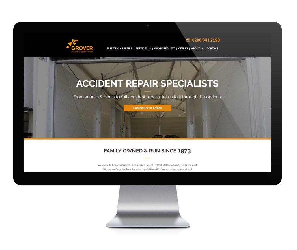 A computer monitor is displaying a website for accident repair specialists.