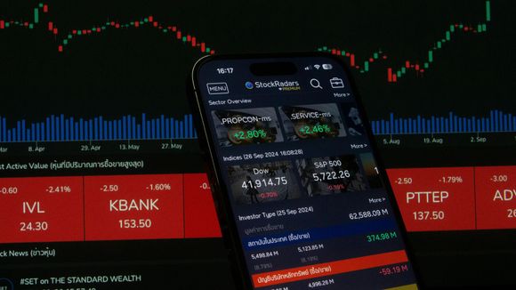 Smartphone displaying a stock‑trading app with financial charts and market data reflecting frozen securities in Euroclear