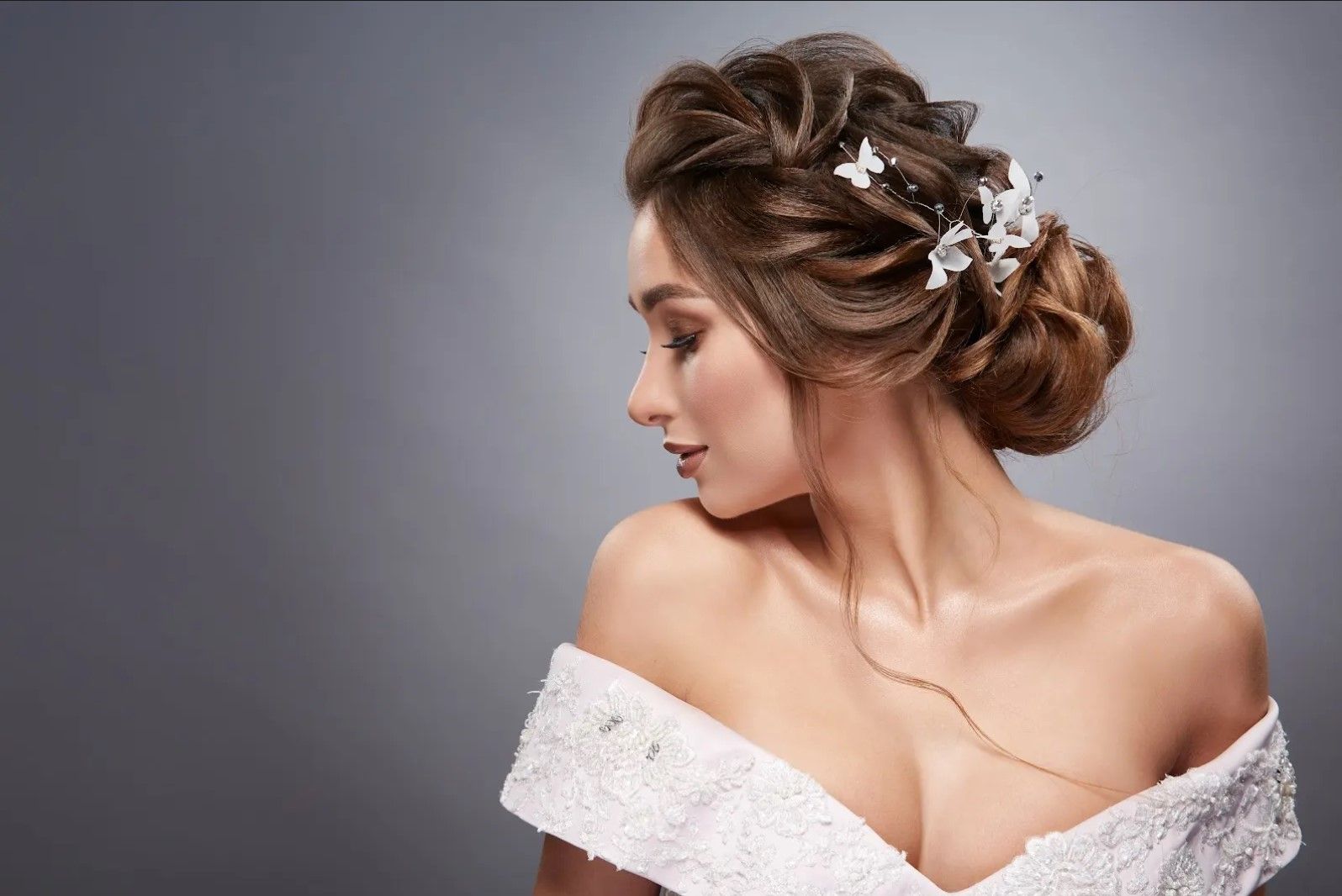 A woman in a wedding dress with a bun in her hair.