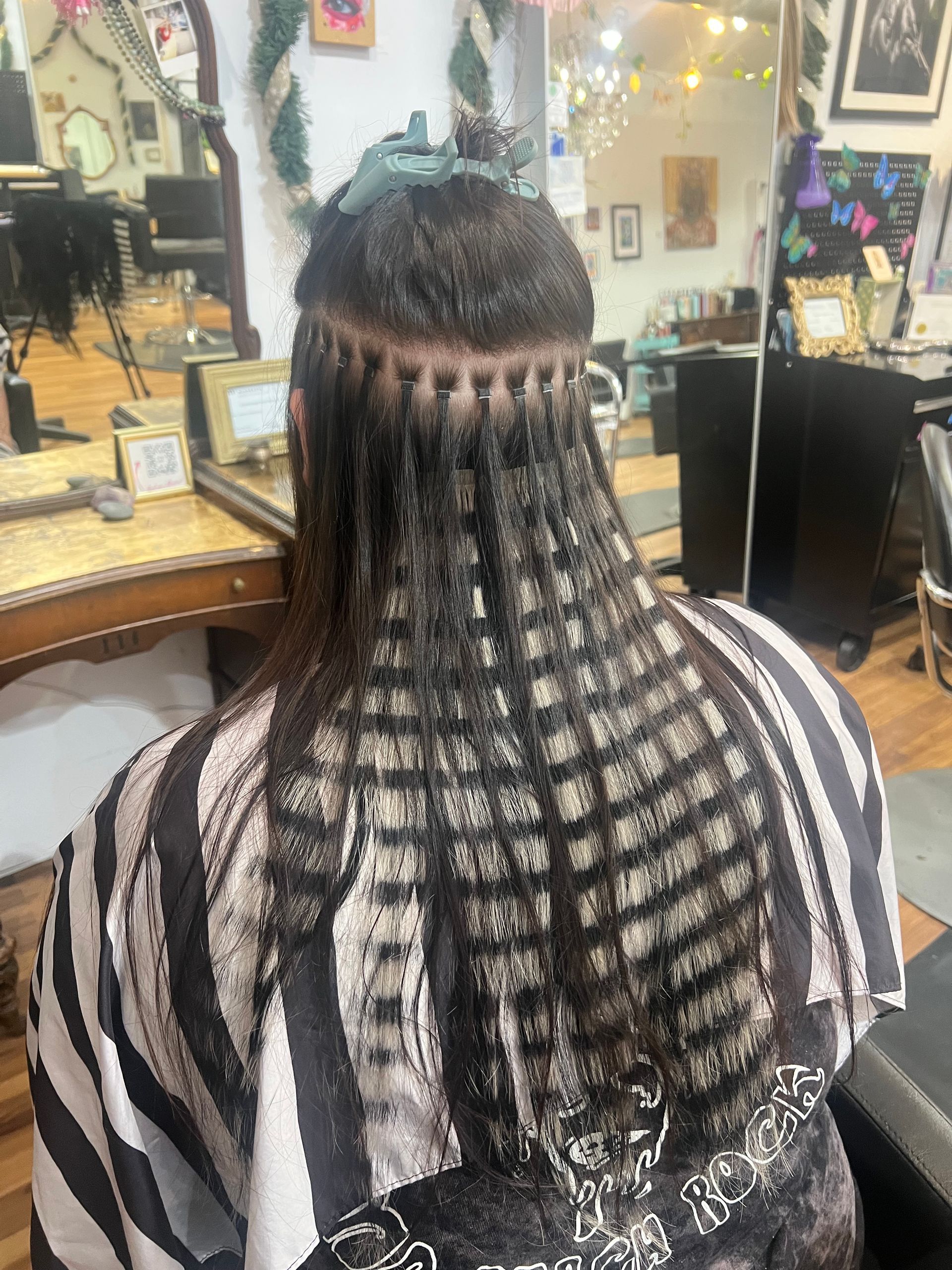 A woman is getting her hair done in a salon.