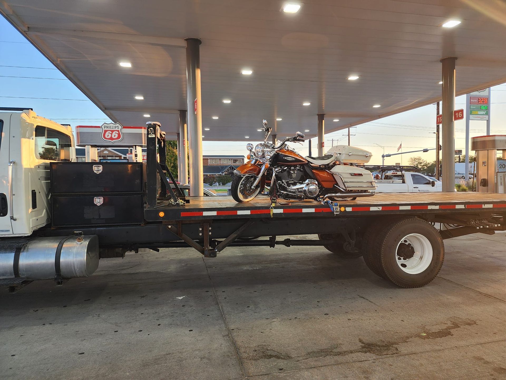 A man is holding a red gas can in front of a car.