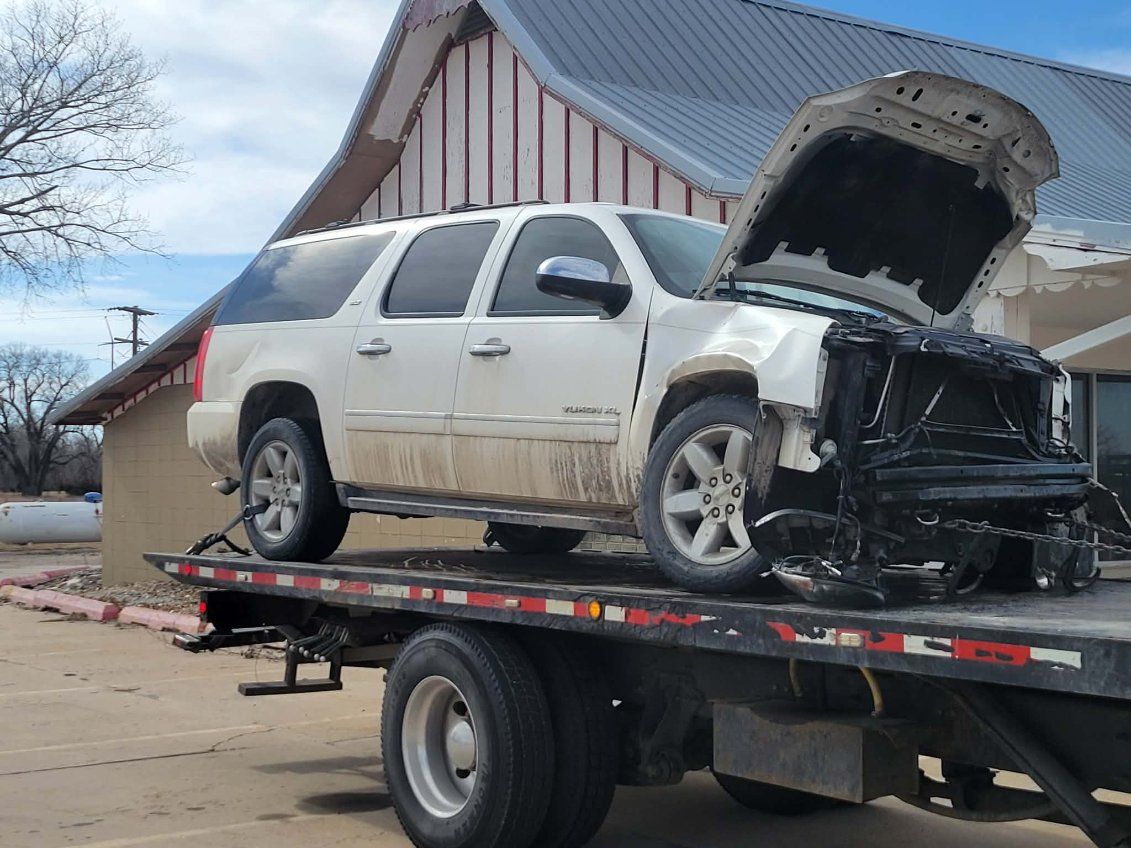 Two semi trucks are parked on the side of the road.