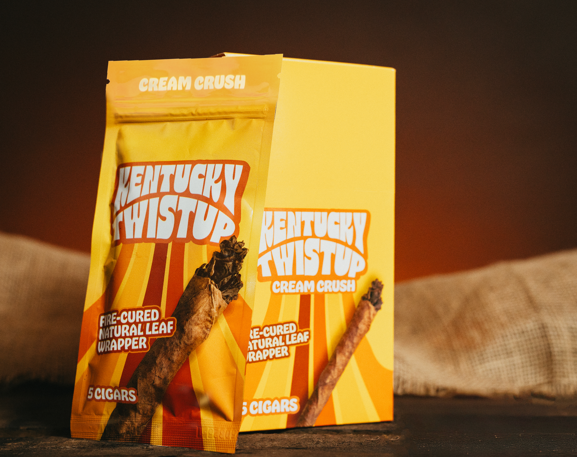 A bag of kentucky twistup cigars sits next to a box of cigars