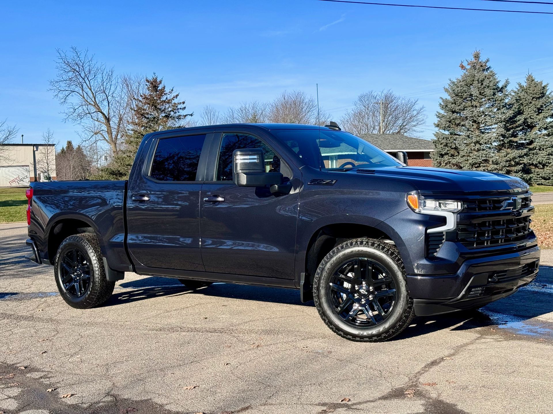 Dark gray Chevrolet Silverado pickup truck parked on pavement.