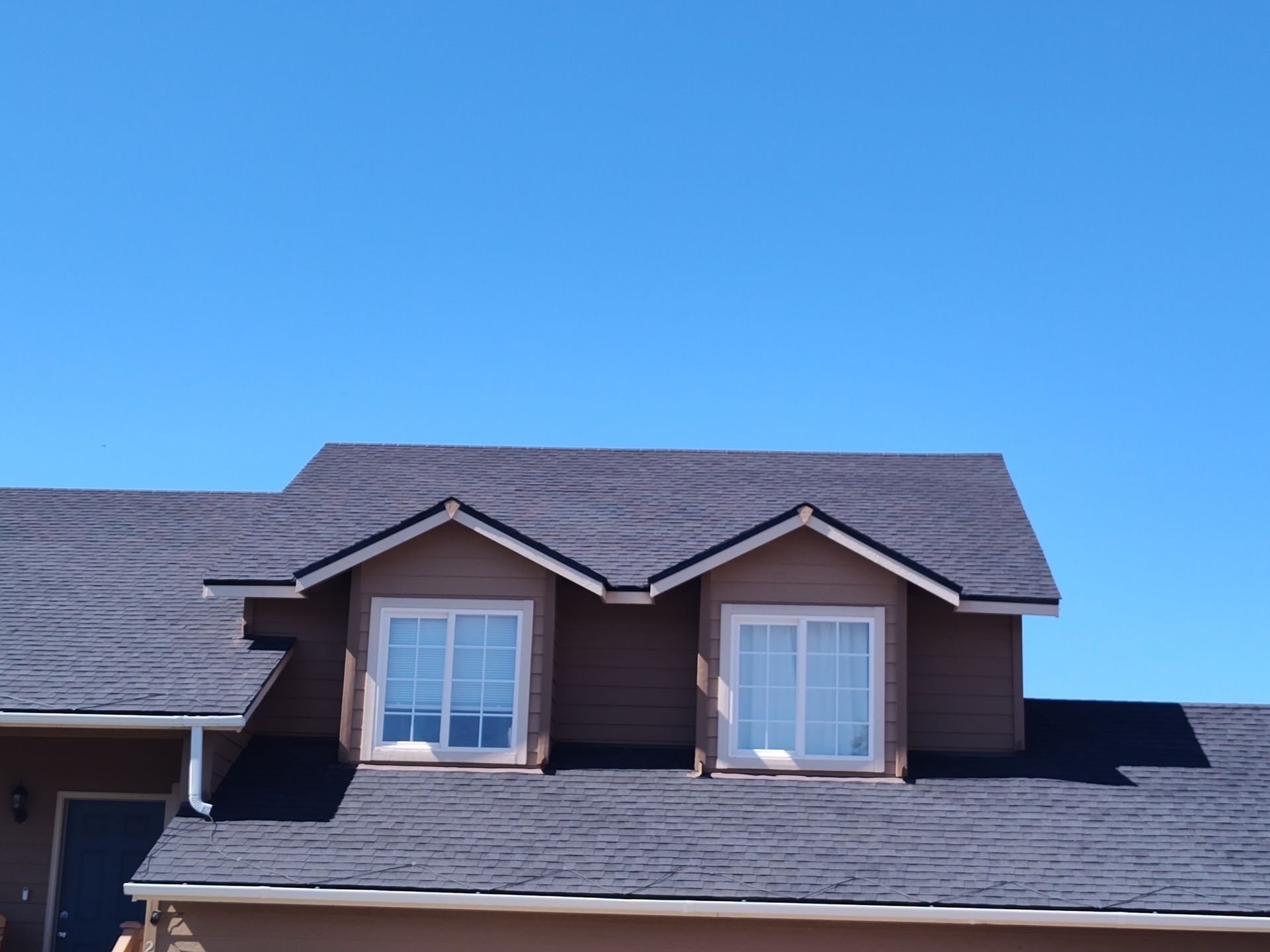 A house with a red roof and a blue sky in Malaga, WA