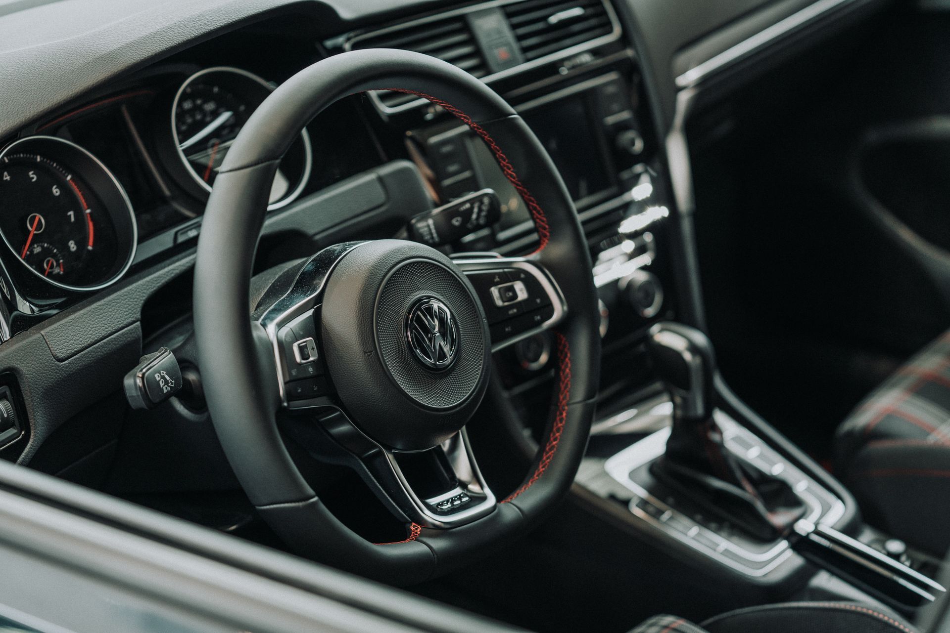 A close up of a steering wheel in a car.
