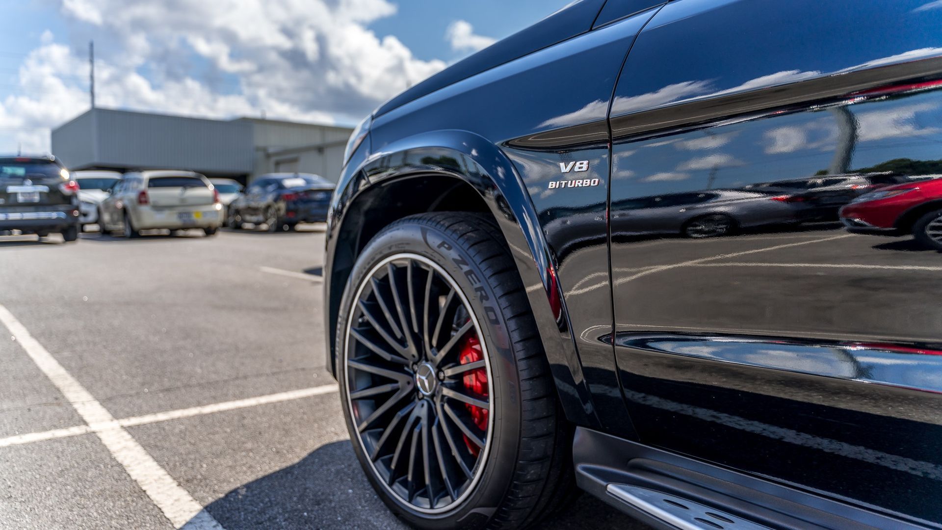A black mercedes benz gls 63 amg is parked in a parking lot.
