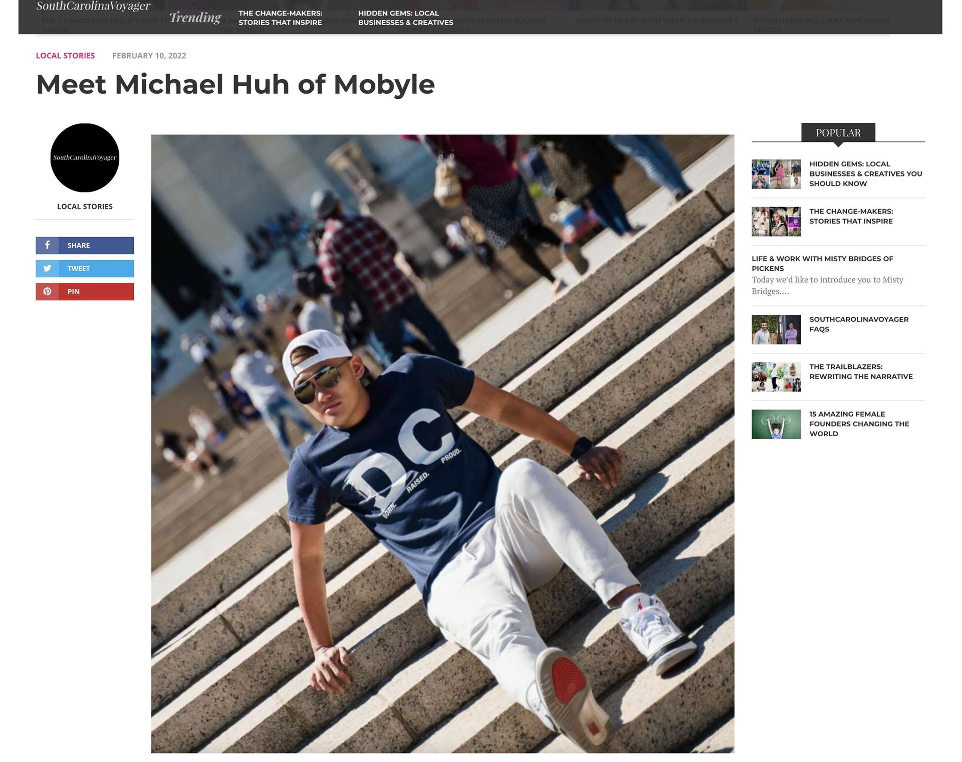 A man is laying on the ground on a set of stairs.