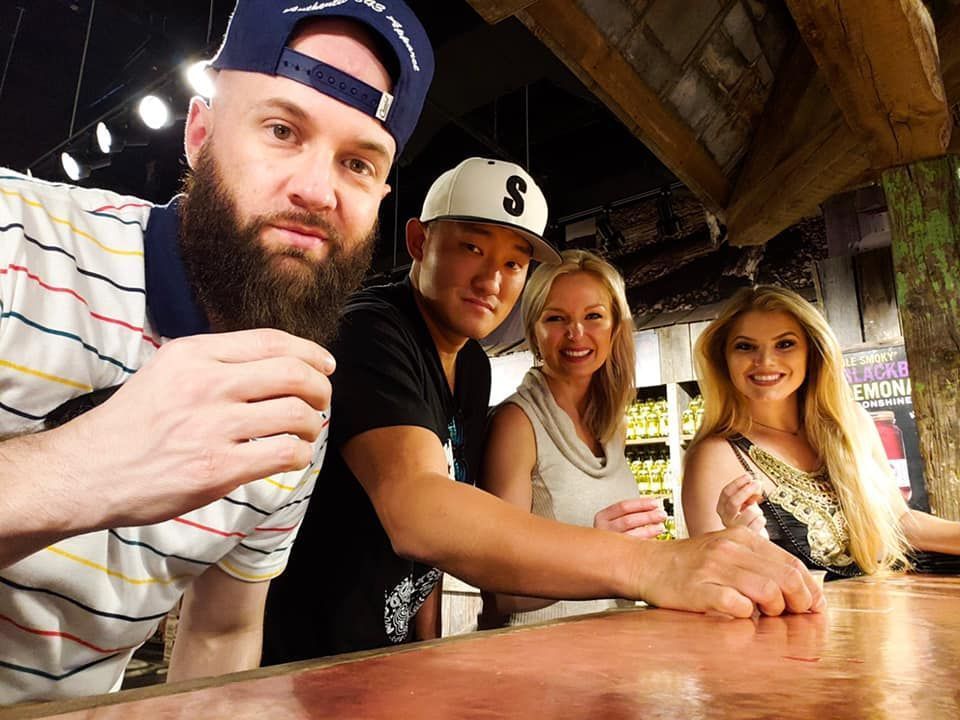 A group of people are posing for a picture at a bar.