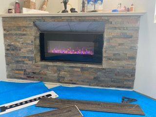 A fireplace is being installed in a living room.