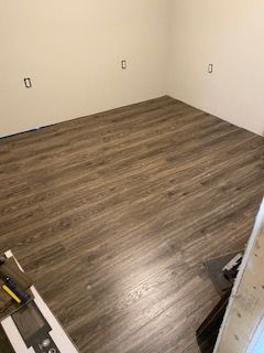 A room with a wooden floor and white walls.