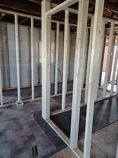 A room that is being built with a lot of wooden beams