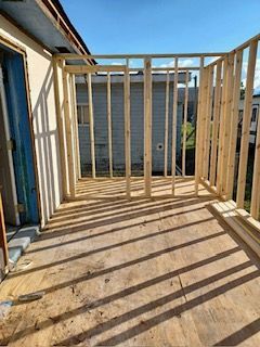 A wooden deck is being built on top of a house.