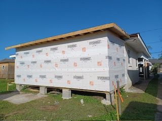 A house that is being built with styrofoam on the side