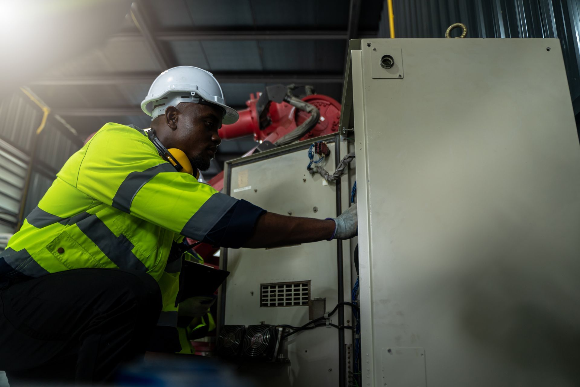 A man is working on a machine in a factory.