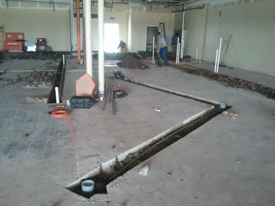 A man is standing in a room with a lot of pipes in it