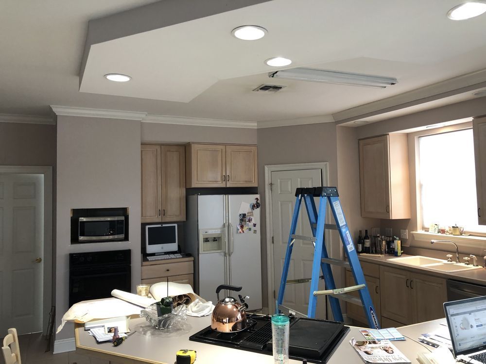 A kitchen with a blue ladder sitting on the counter.