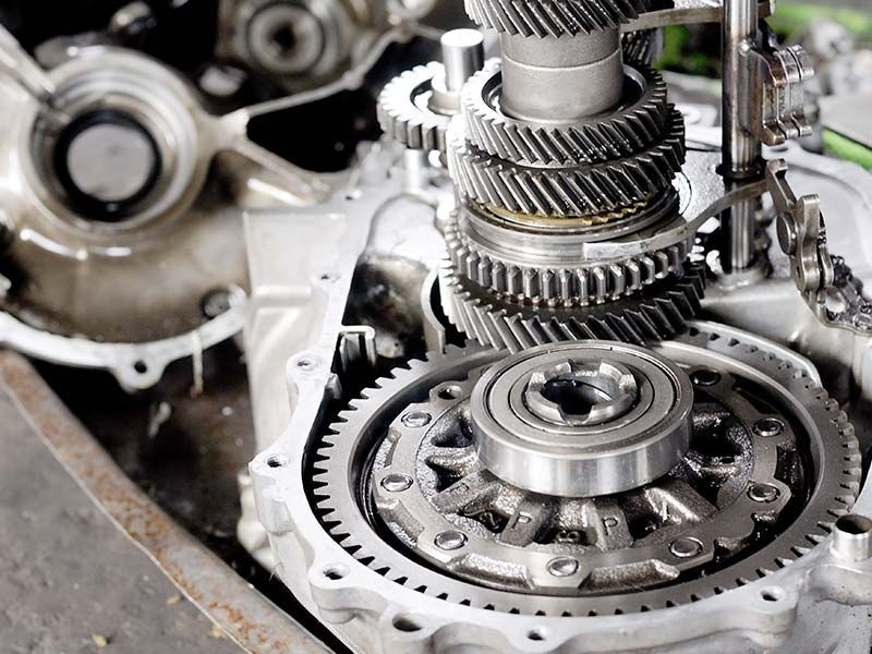 A close up of a car engine with gears and bearings