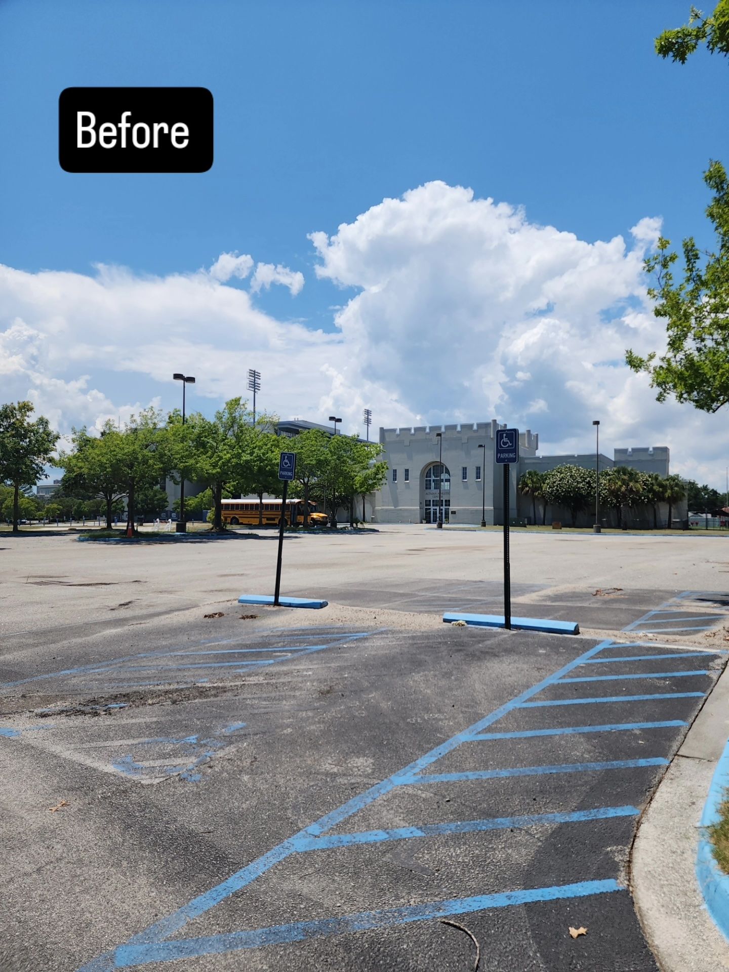 An empty parking lot with a truck parked in front of a building