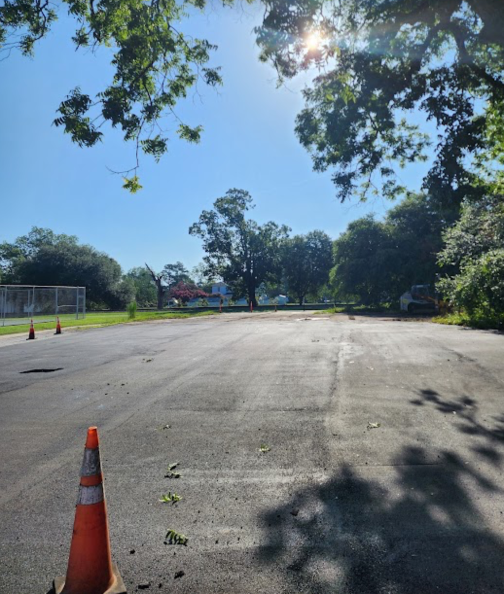 An empty parking lot with an orange cone in the middle