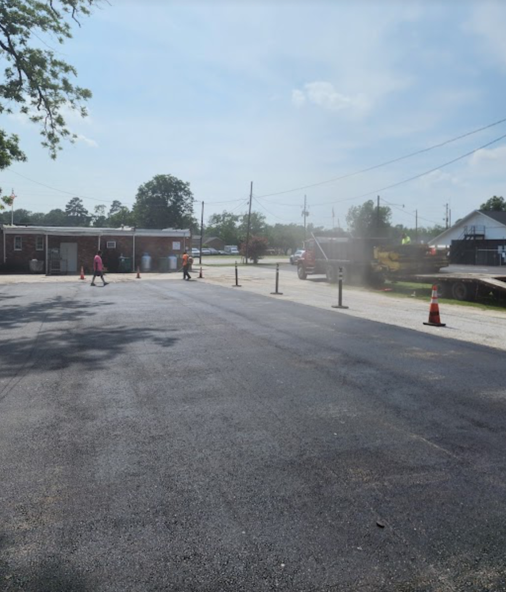 A group of people are walking down a street in front of a building