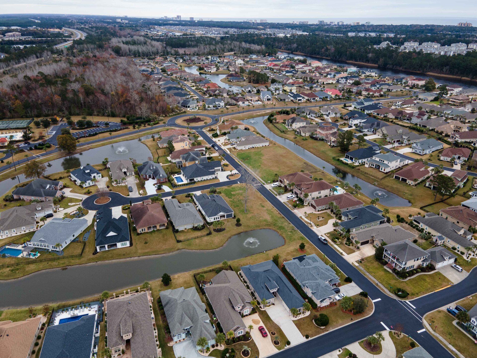 An aerial view of a residential area with a river in the background