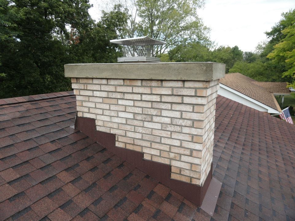 An after photo of a brick chimney on top of a brown roof – Dayton, OH - Miami Valley Chimney
