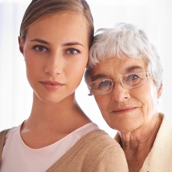 A young woman and an aging woman are posing for a picture representing aging
