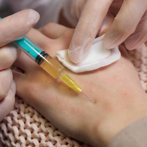A person is holding a syringe in their hand, getting Effective Treatment for Blood Disorders with Orthobiologics, in Morris Plains, New Jersey and Manhattan New York