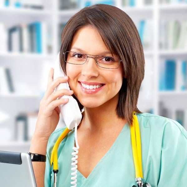 A female doctor is smiling while talking on a phone with a patient who contacted Victory Medical Institute for GLP-1 Weight Loss Treatments, Serving Patients in Morris Plains, New Jersey, and Manhattan, New York