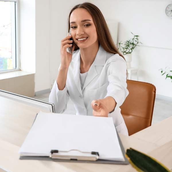 Receptionist speaking with a patient Contact Victory Medical for a Testosterone Therapy Consultation